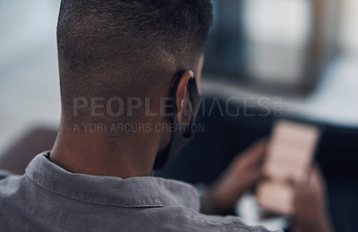Buy stock photo Closeup shot of a businessman wearing a face mask while using a cellphone in an office