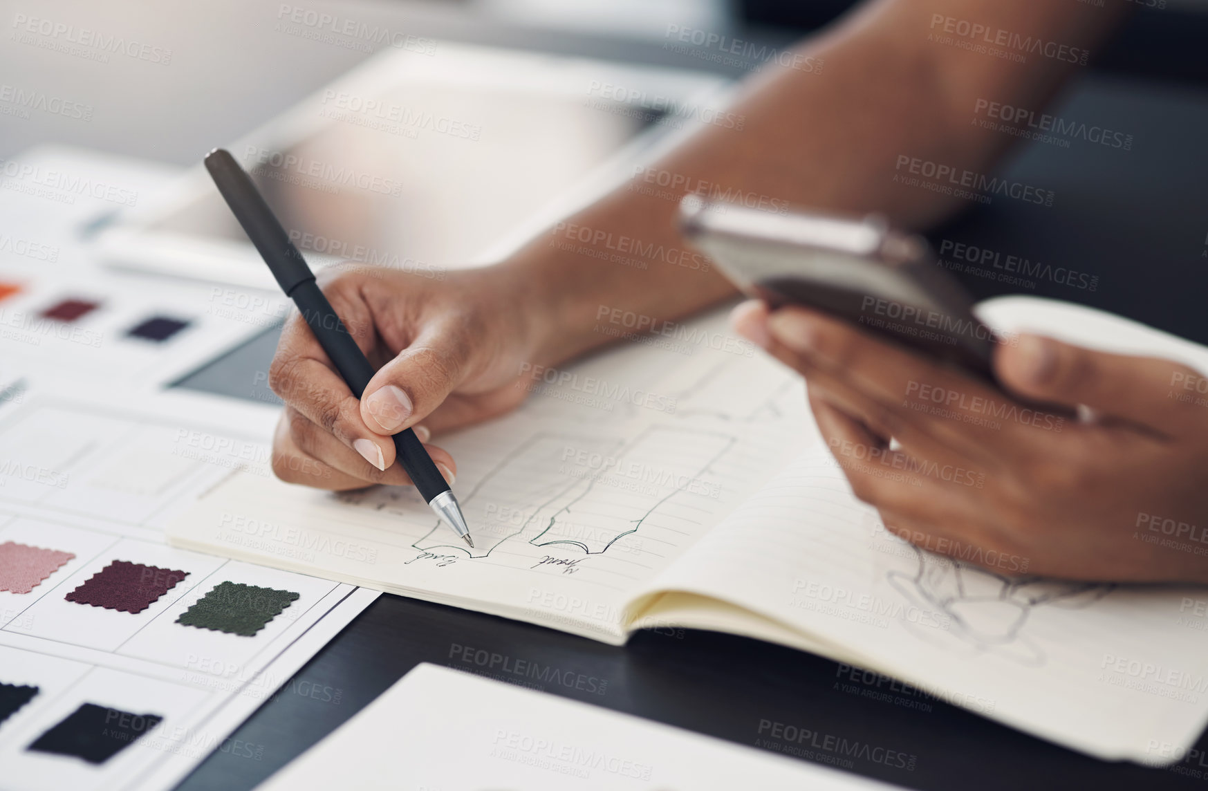 Buy stock photo Closeup shot of an unrecognisable designer using a cellphone while sketching in a notebook in an office