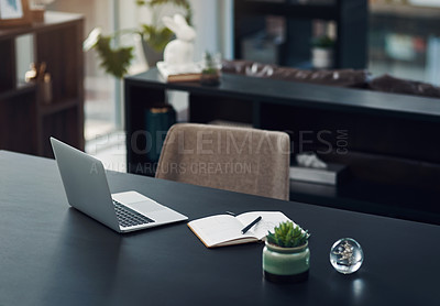 Buy stock photo Still life shot of a laptop and notebook on a table in an office