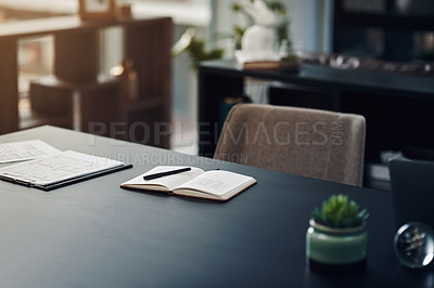 Buy stock photo Still life shot of a notebook and paperwork on a table in an office