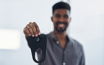 Buy stock photo Portrait of a young businessman holding a face mask in an office