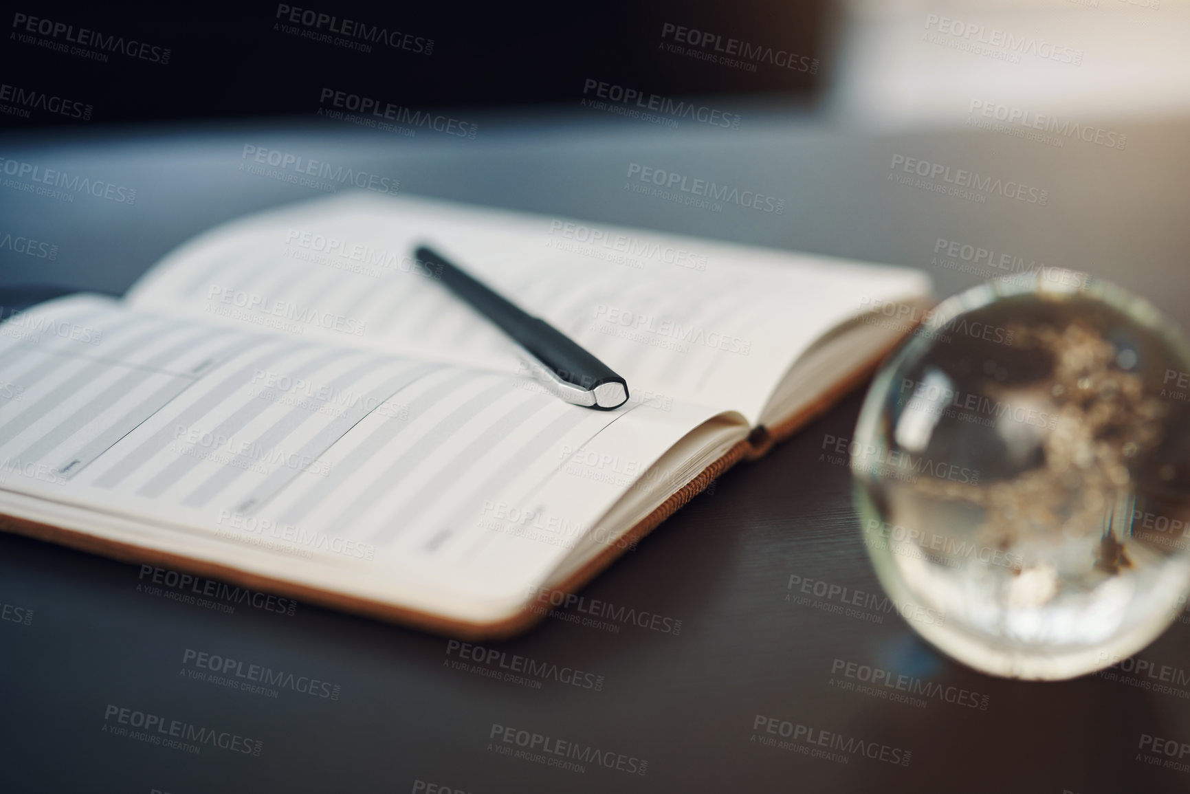 Buy stock photo Still life shot of a notebook and pen on a table in an office