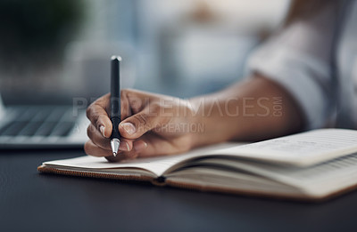 Buy stock photo Closeup shot of an unrecognisable woman writing notes in an office
