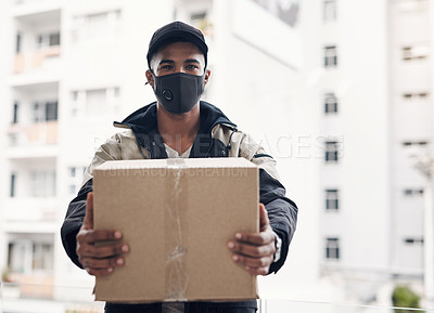 Buy stock photo Shot of a masked young man delivering a package to a place of residence