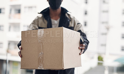 Buy stock photo Cropped shot of a masked man delivering a package to a place of residence
