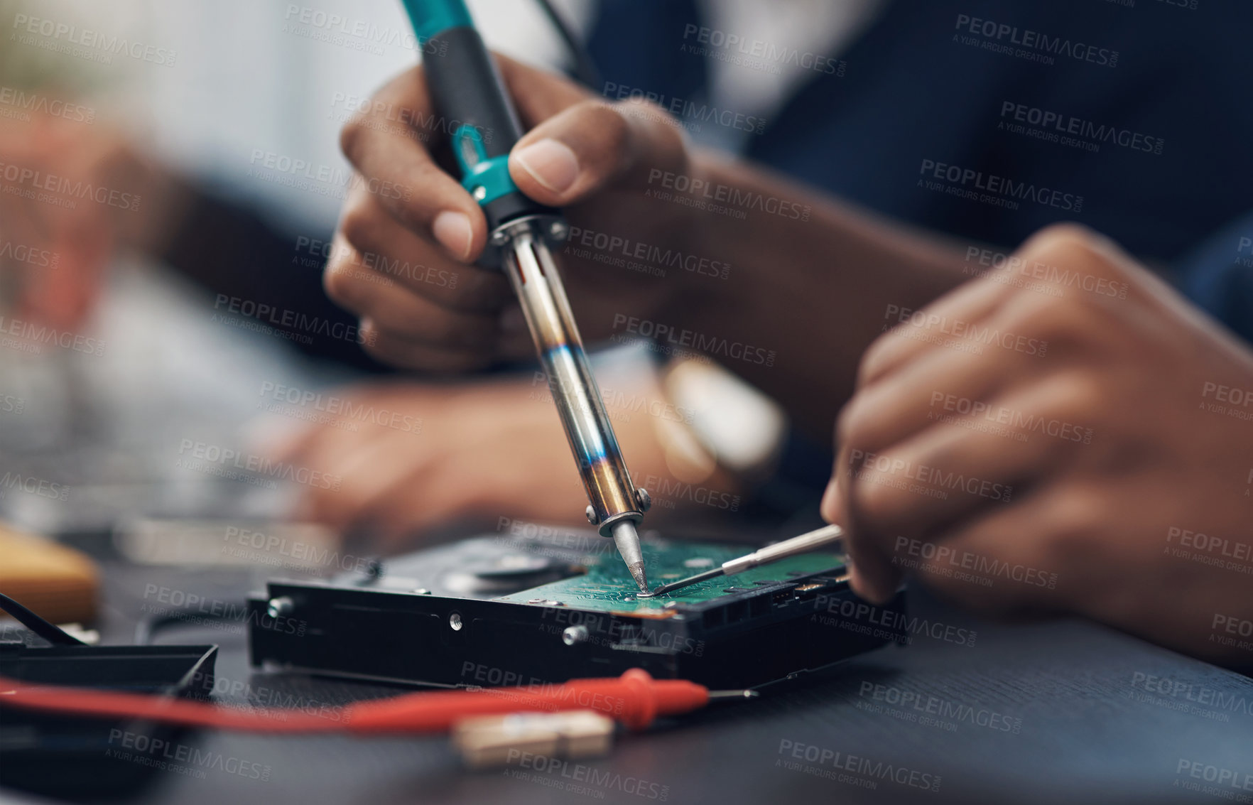 Buy stock photo Shot of a technician using a soldering iron 	to repair computer hardware