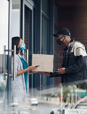 Buy stock photo Shot of a masked young woman receiving a delivery at home
