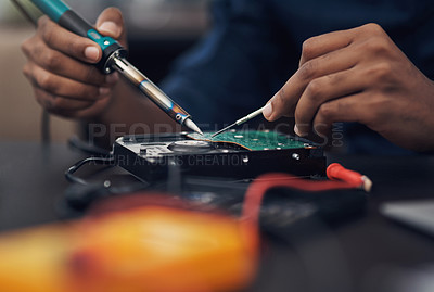 Buy stock photo Shot of a technician using a soldering iron 	to repair computer hardware