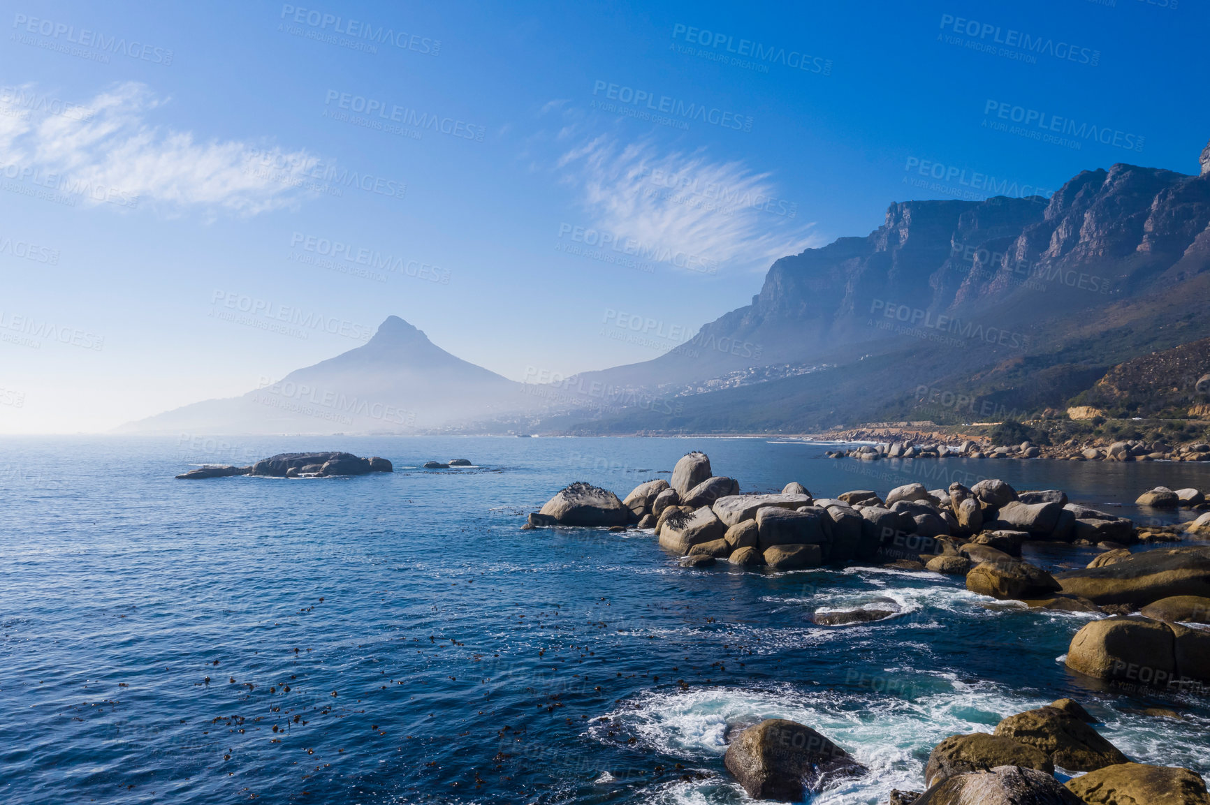 Buy stock photo Shot of a mountainous landscape along the sea