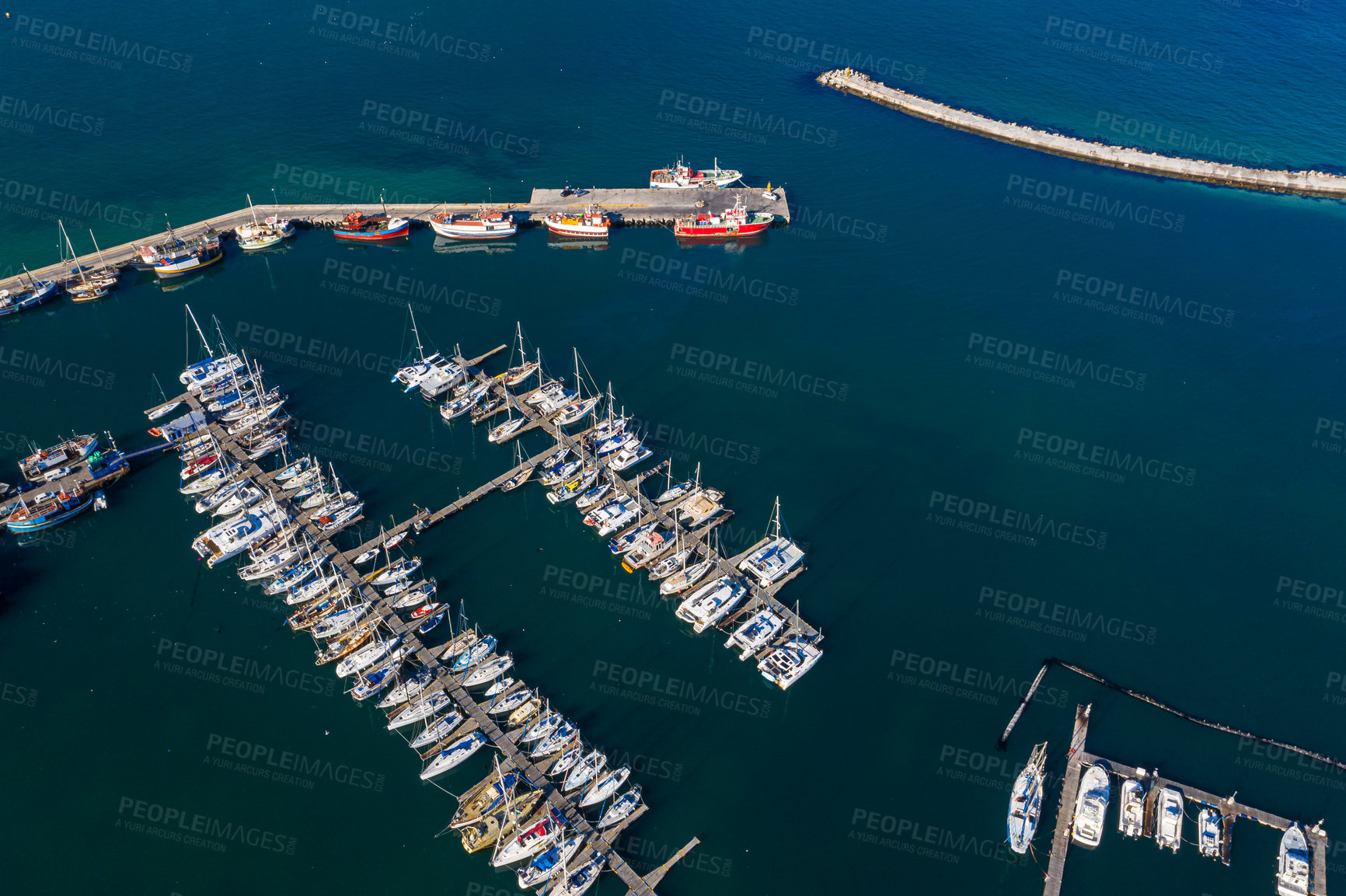 Buy stock photo Aerial drone, boats and harbour with ocean, port and marina for travel or cruise holiday. Top view, dock and sea with sailboat, nautical pier or jetty with water scenery and panorama background