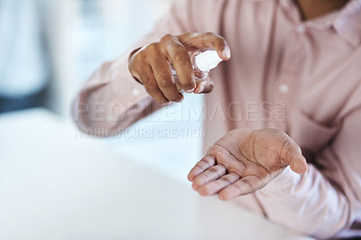Buy stock photo Closeup shot of an unrecognisable businessman using hand sanitiser in an office
