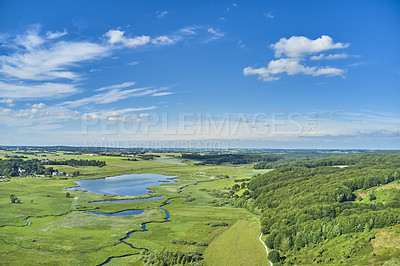 Buy stock photo Countryside of Jutland, Denmark. Beautiful landscape showing the Danish wilderness. Pastures on a bright summer day with lush greenery flourishing and a blue sky filled with clouds. 
