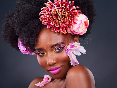 Buy stock photo Studio shot of a beautiful young woman posing with flowers in her hair