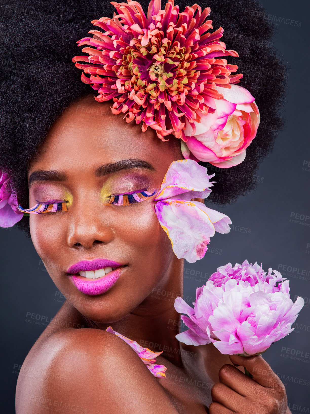 Buy stock photo African, woman and beauty with flowers, smile and lashes for makeup, skincare and confidence in studio. Female person, pose and happy for fashion, style and luxury in grey background for cosmetics