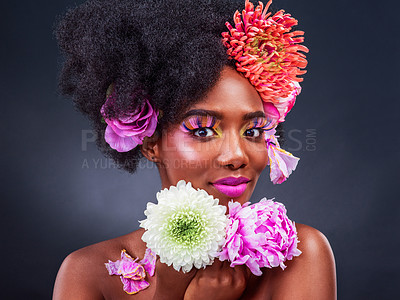 Buy stock photo Beauty, flowers and portrait of black woman at salon on dark background for natural cosmetics. Aesthetic, face or makeup and young afro model with protea in hair for aesthetic wellness in studio