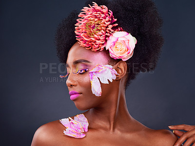 Buy stock photo Flowers, makeup and profile of happy black woman for natural, cosmetics and spring. Makeup, eco friendly and floral with face of female model in studio for aesthetic, self love and organic skincare.