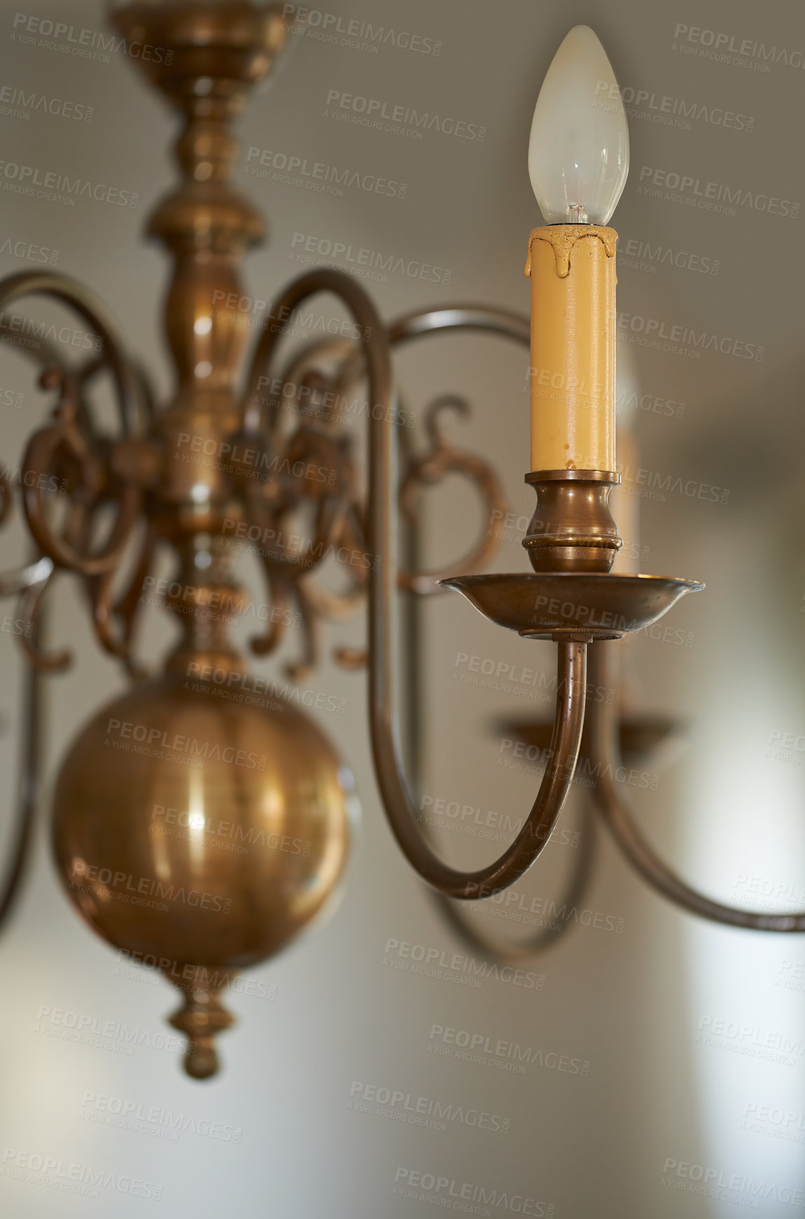 Buy stock photo Closeup of a vintage brass chandelier hanging as decoration in a foyer, entrance hall or dinning room during a blackout. Golden candle like lighting decor for a royal victorian style interior design