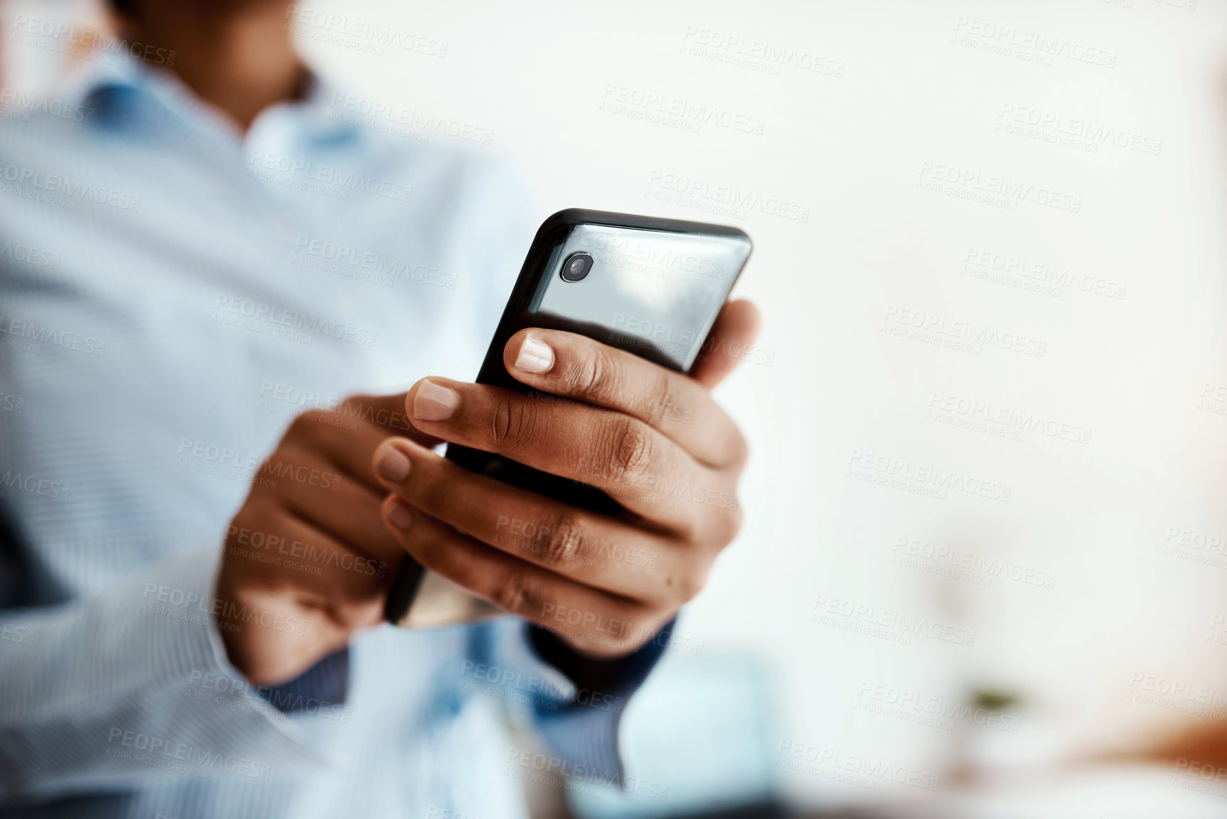 Buy stock photo Cropped sot of an unrecognisable businesswoman using a smartphone