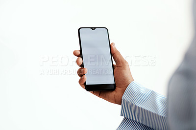 Buy stock photo Cropped studio sot of an unrecognisable businesswoman using a smartphone against a white background