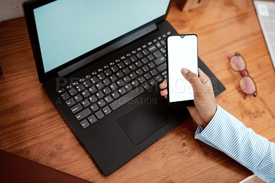 Buy stock photo Cropped shot of a businesswoman using a laptop and smartphone at her desk