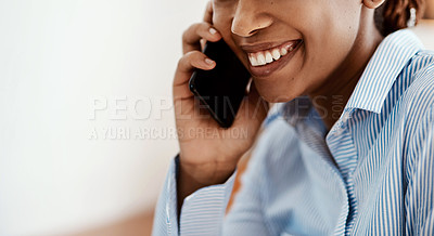 Buy stock photo Cropped shot of a young businesswoman using a smartphone while working from home