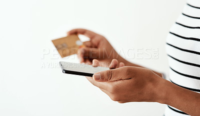 Buy stock photo Cropped shot of a woman using a smartphone and credit card against a white studio background