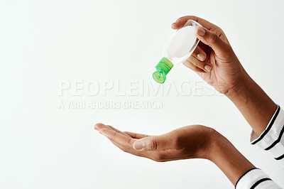 Buy stock photo Cropped shot of a woman using hand sanitiser against a white studio background