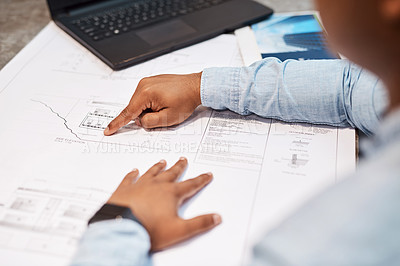 Buy stock photo Shot of an unrecognisable architect drawing up a building plan in a modern office