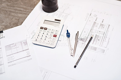 Buy stock photo Shot of a calculator, pencil, blueprint and compass on a desk in an office
