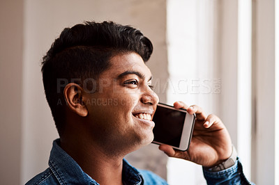 Buy stock photo Cropped shot of a young businessman talking on his cellphone