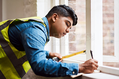 Buy stock photo Architect, man and writing measurement for construction, renovation or maintenance project by window. Engineer tools, tape or notes for building size, inspection planning or accuracy for home repairs