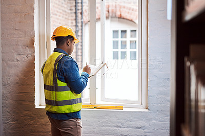 Buy stock photo Shot of a engineer making notes while on a construction site