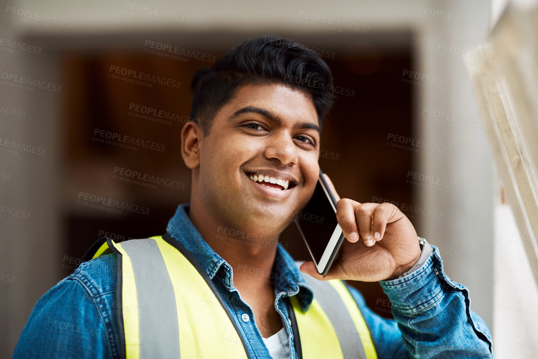 Buy stock photo Cropped shot of a engineer talking on his cellphone while on a construction site