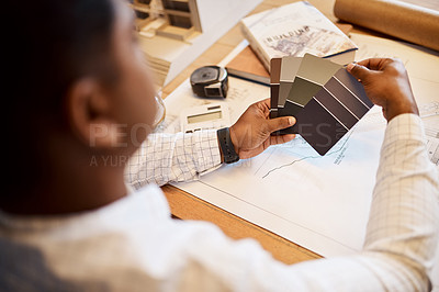 Buy stock photo Shot of an architect deciding on a colour scheme while working on a project