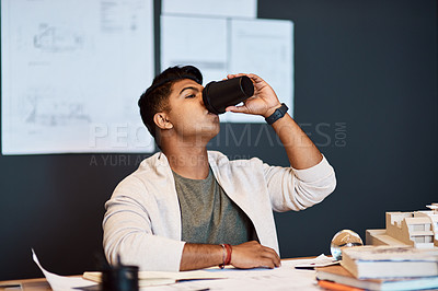 Buy stock photo Shot of a young architect having a coffee break while working in a modern office
