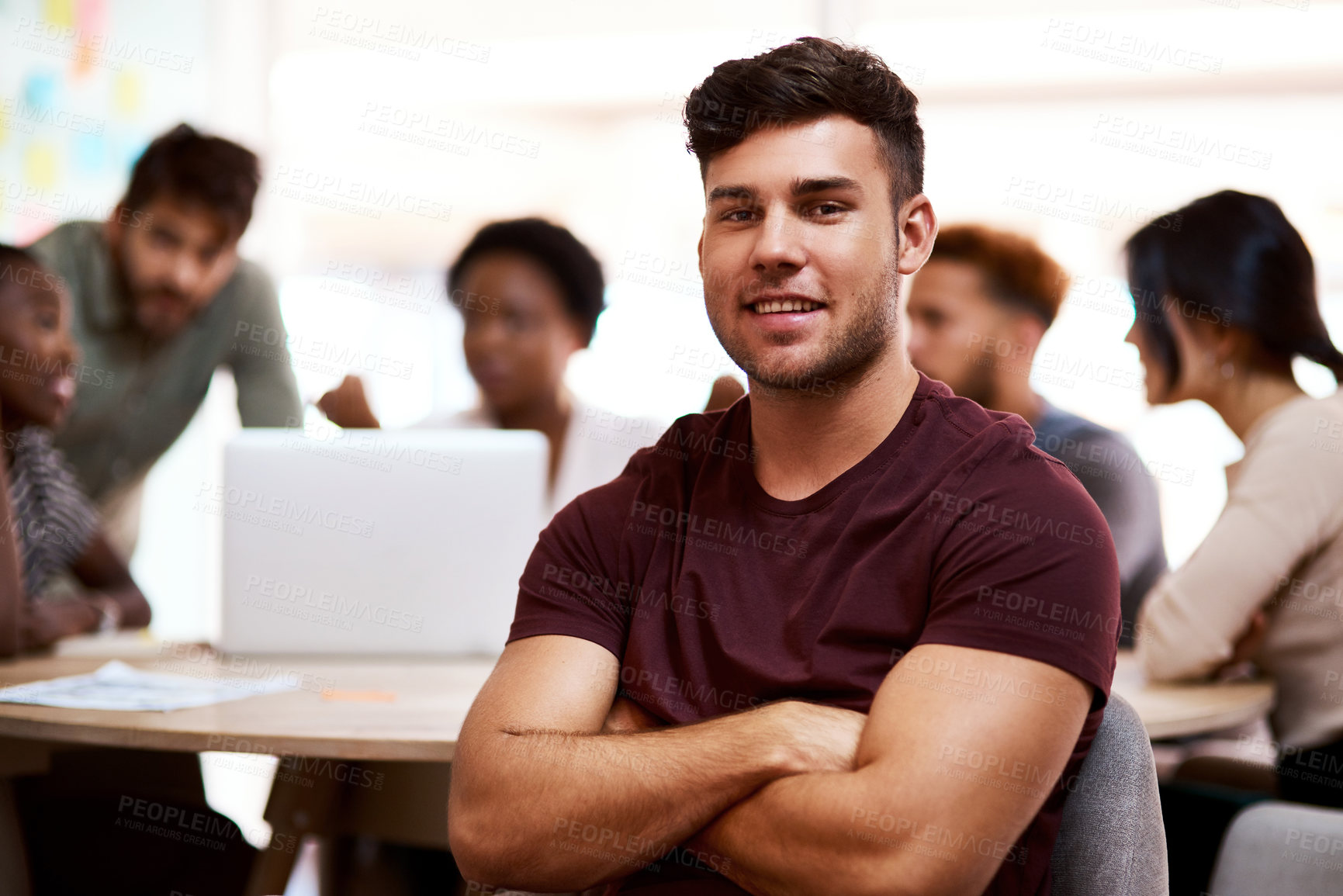 Buy stock photo Portrait of a confident young businessman sitting in an office