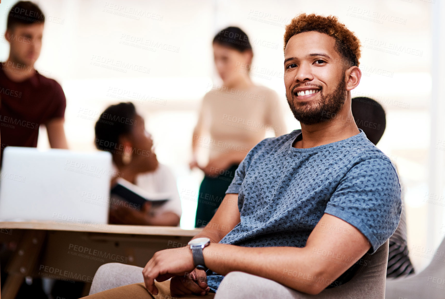 Buy stock photo Portrait of a confident young businessman sitting in an office