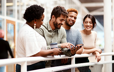 Buy stock photo Shot of a group of young creatives using a digital tablet together in an office