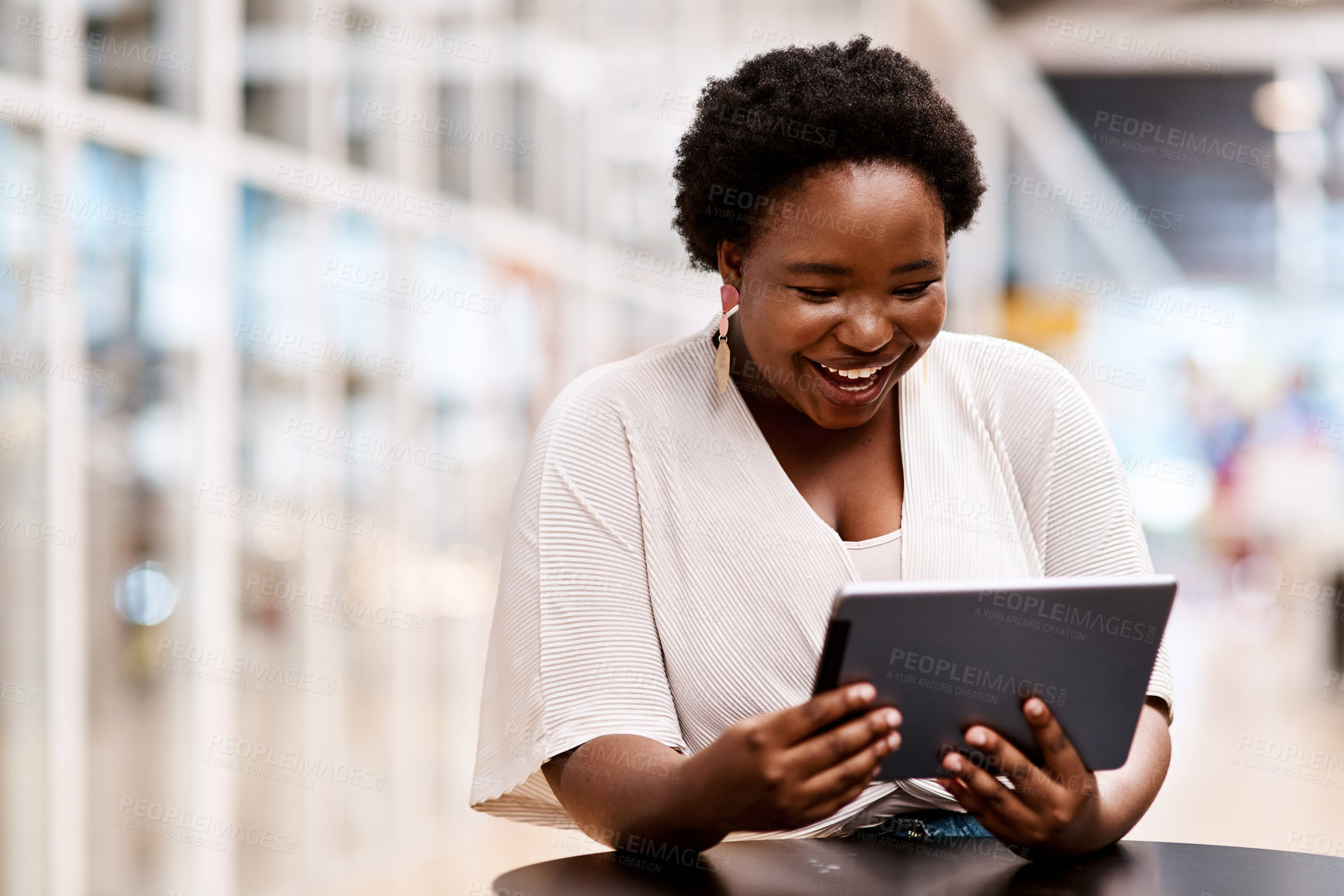 Buy stock photo Shot of a young businesswoman using a digital tablet in an office