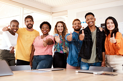 Buy stock photo Cropped portrait of a group of young designers giving thumbs up to the camera while standing in the boardroom of their office
