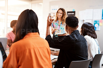 Buy stock photo Rearview shot of an unrecognizable male designer raising his hand while sitting in the boardroom during a meeting