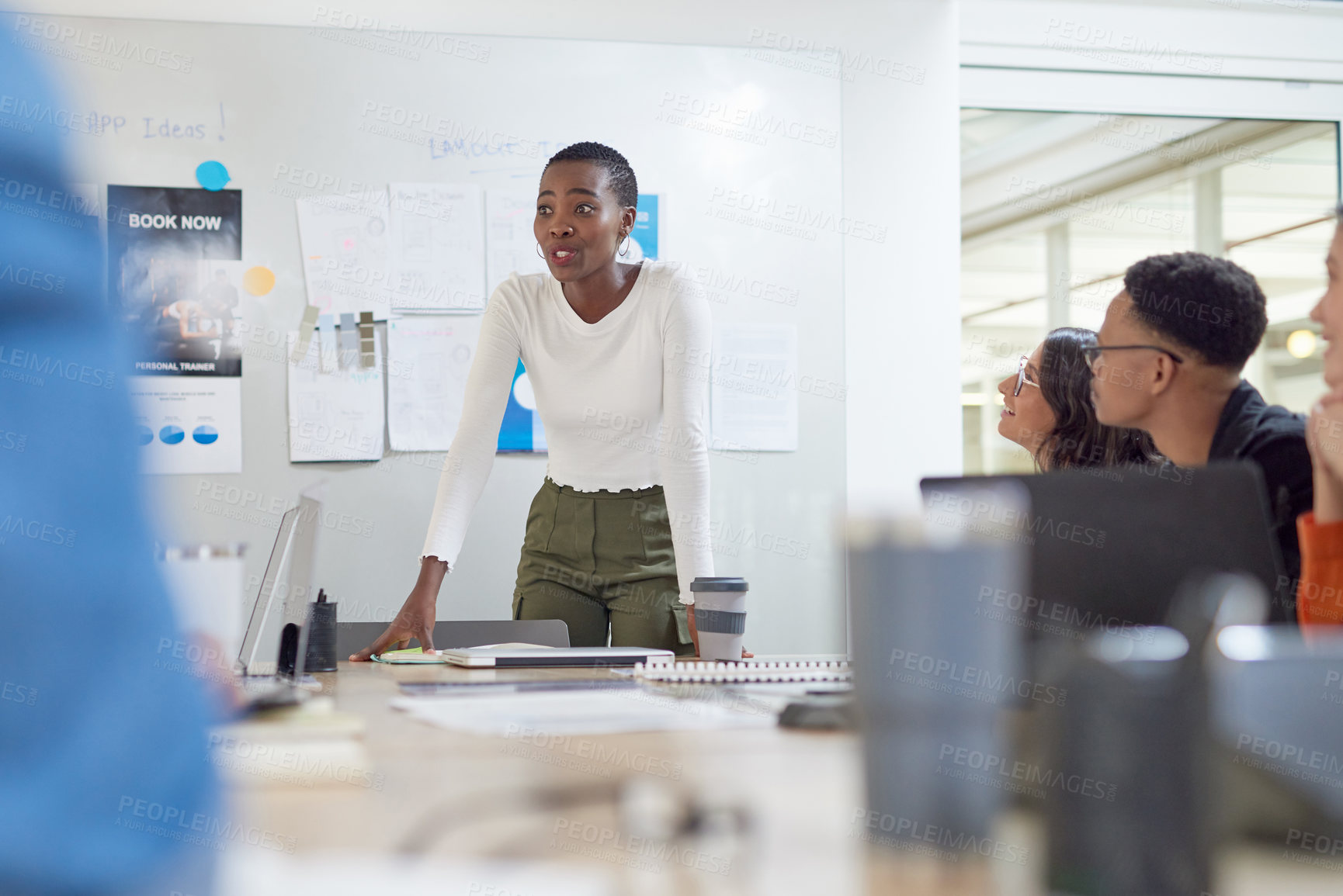 Buy stock photo Shot of a young businesswoman having a meeting with her colleagues in an office