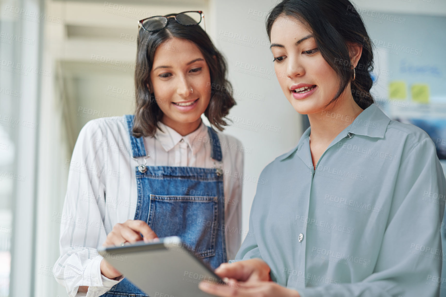 Buy stock photo Creative, discussion and business women with tablet, collaboration and brainstorming online. Ideas, workshop and design team in office with digital app for research, growth and startup development
