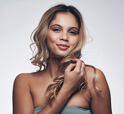 Buy stock photo Cropped shot of a beautiful young woman posing against a grey background