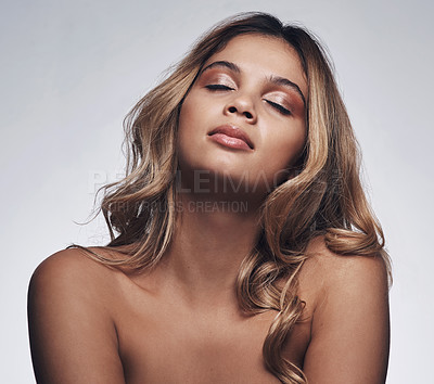 Buy stock photo Cropped shot of a beautiful young woman posing against a grey background