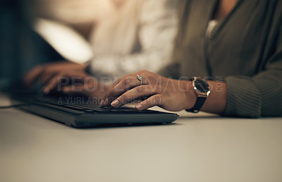 Buy stock photo Closeup shot of an unrecognisable businesswoman working on a computer in an office at night