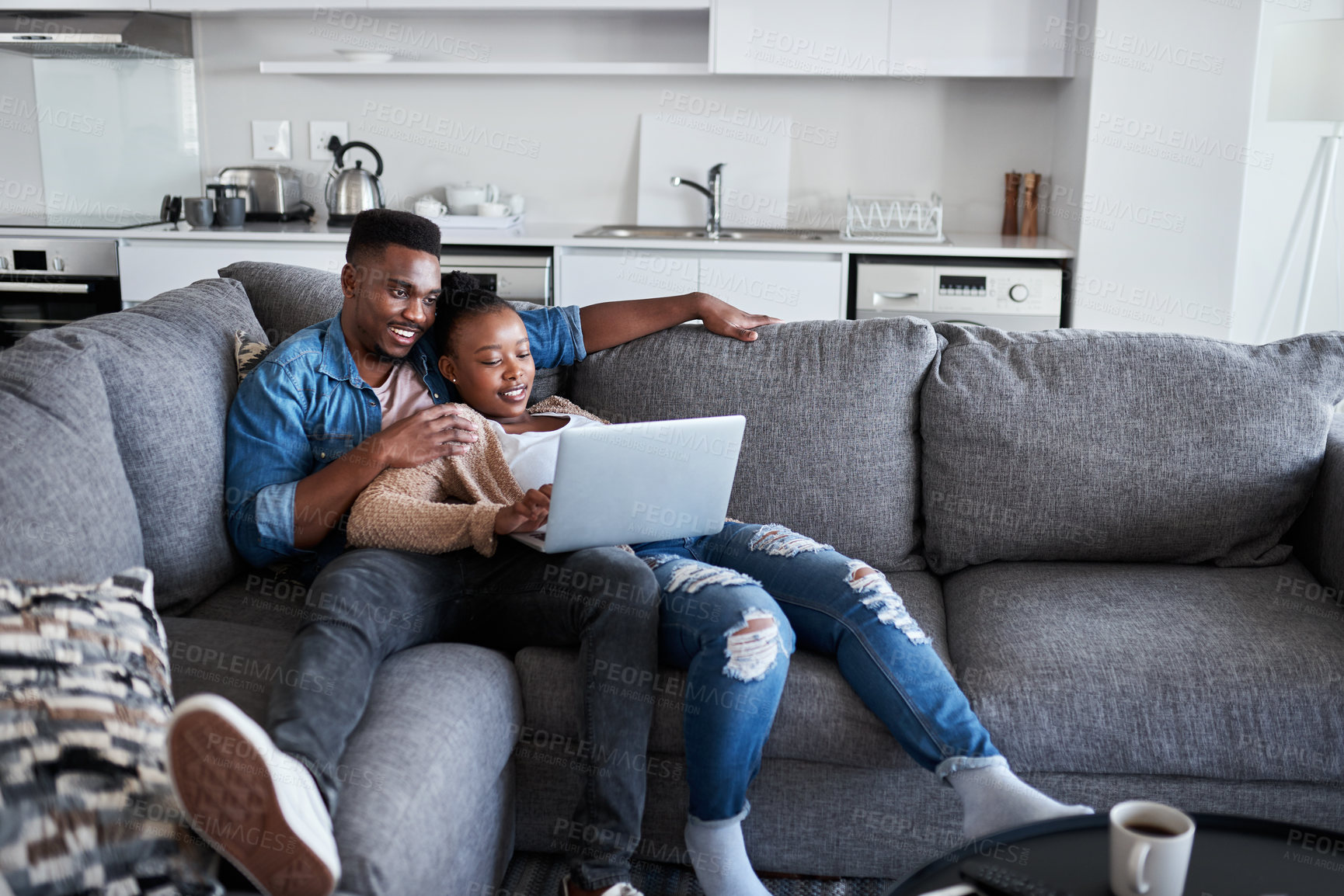 Buy stock photo Couple, laptop and watch movie while lying on the living room couch for relaxation. Internet, pc and online social media browsing with an african american man and woman using a laptop for streaming