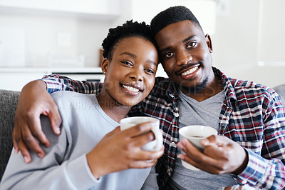 Buy stock photo Portrait of a young couple drinking coffee while relaxing together at home