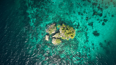 Buy stock photo Drone, ocean or island and rock in water for summer adventure, travel location or holiday destination. Aerial view, beach or natural environment with tropical landscape or sea background in Indonesia