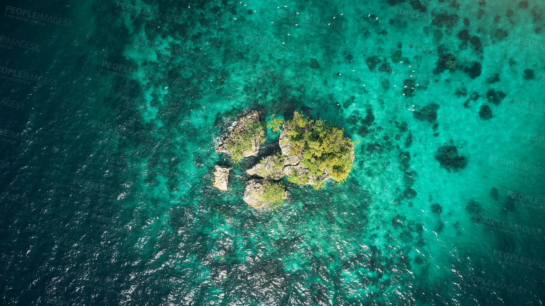 Buy stock photo Drone, ocean or island and rock in water for summer adventure, travel location or holiday destination. Aerial view, beach or natural environment with tropical landscape or sea background in Indonesia